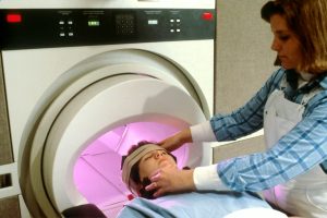 person in blue denim jeans lying on bed getting MRI